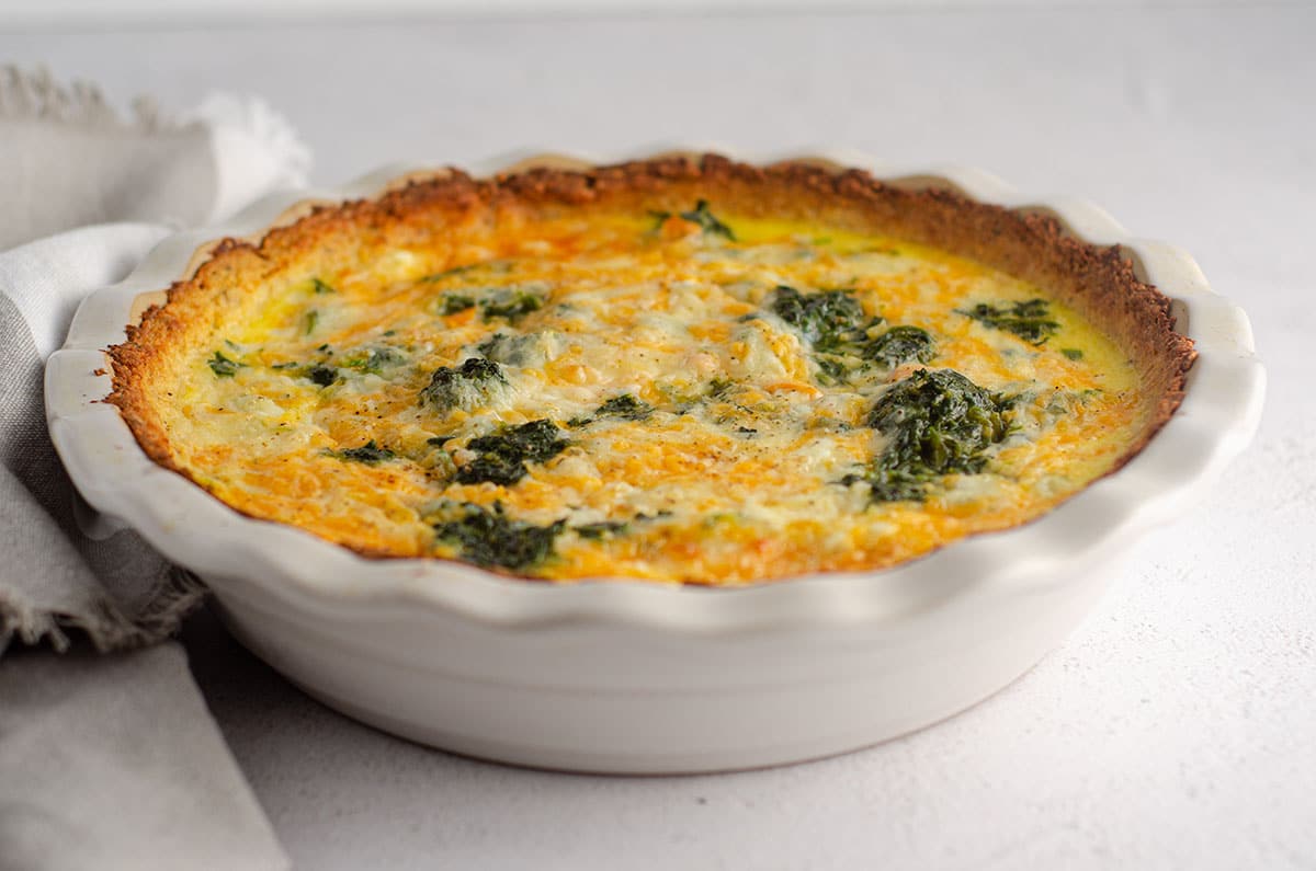 cheesy vegetable quiche with cauliflower crust in a pie plate