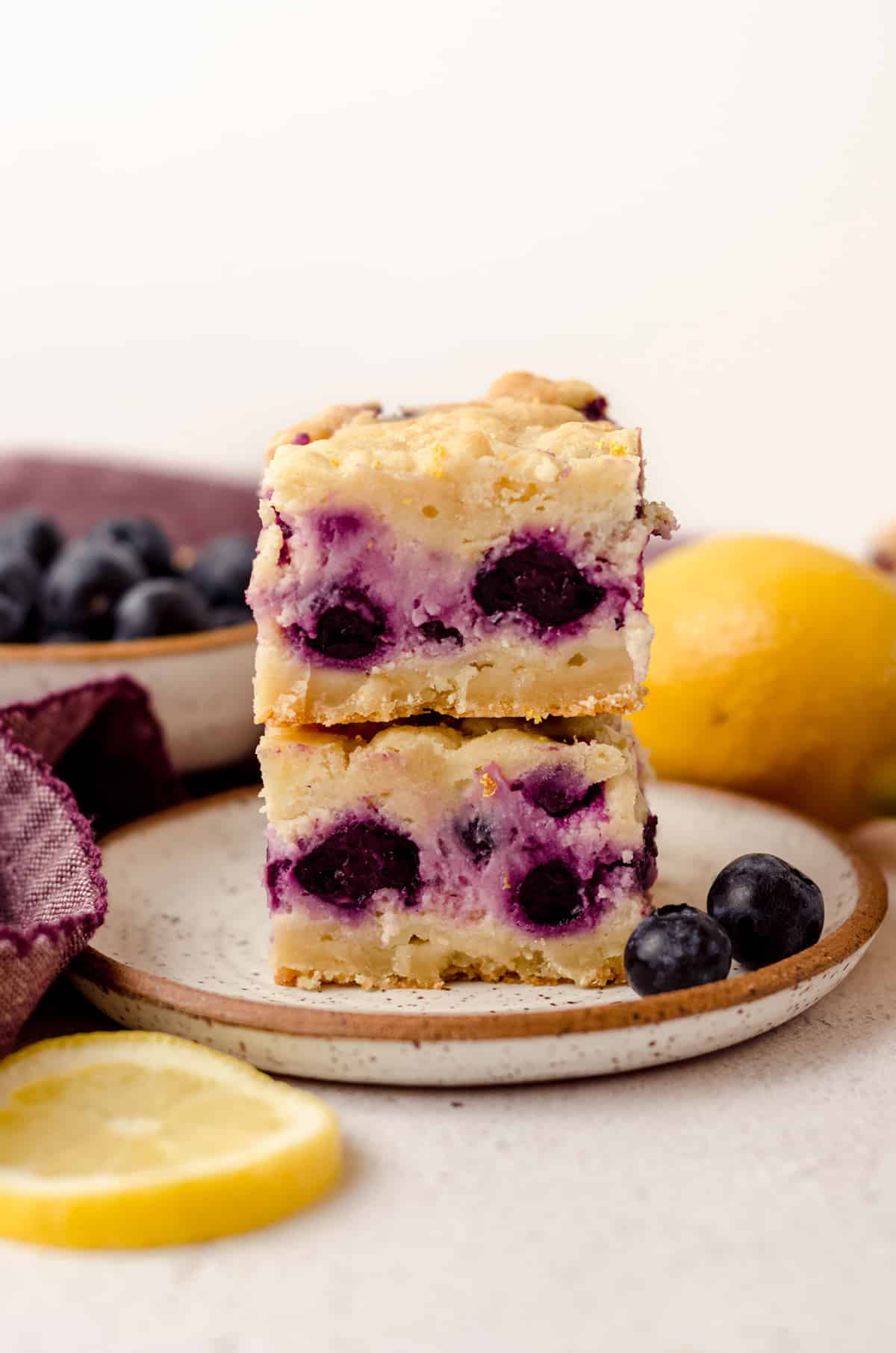 stack of two blueberry lemon bars on a plate