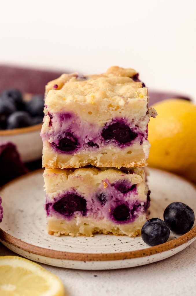 stack of two blueberry lemon bars on a plate