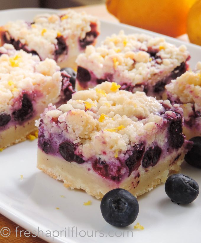 Blueberry Lemon Pie Bars: Creamy and sweet pie bursting with blueberries and citrusy lemon on top of shortbread crust. In portable bar form!