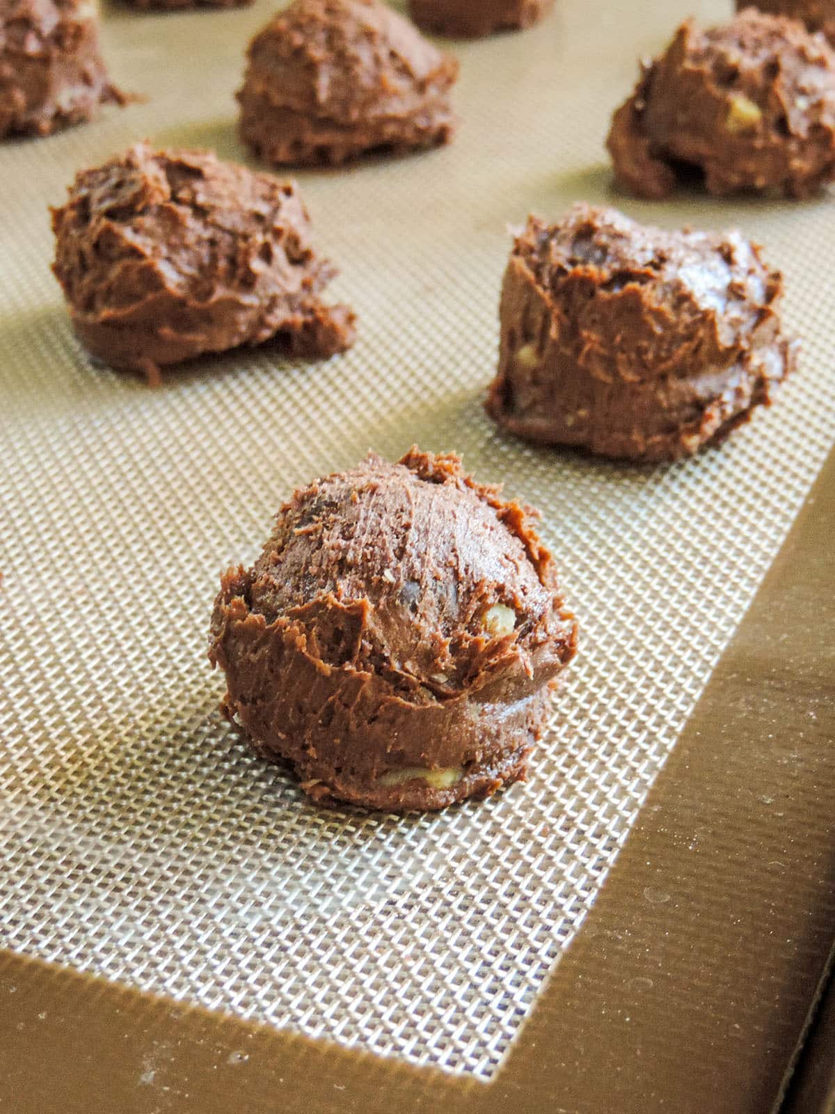 brownie cookie dough balls on a baking sheet