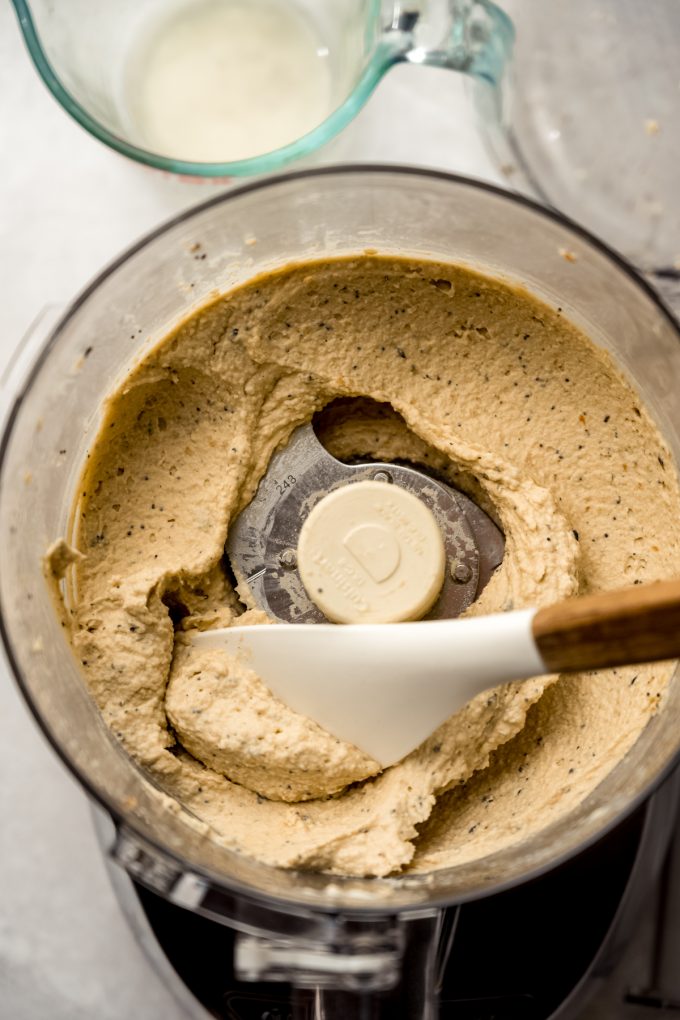 Everything bagel hummus blended in the drum of a food processor.