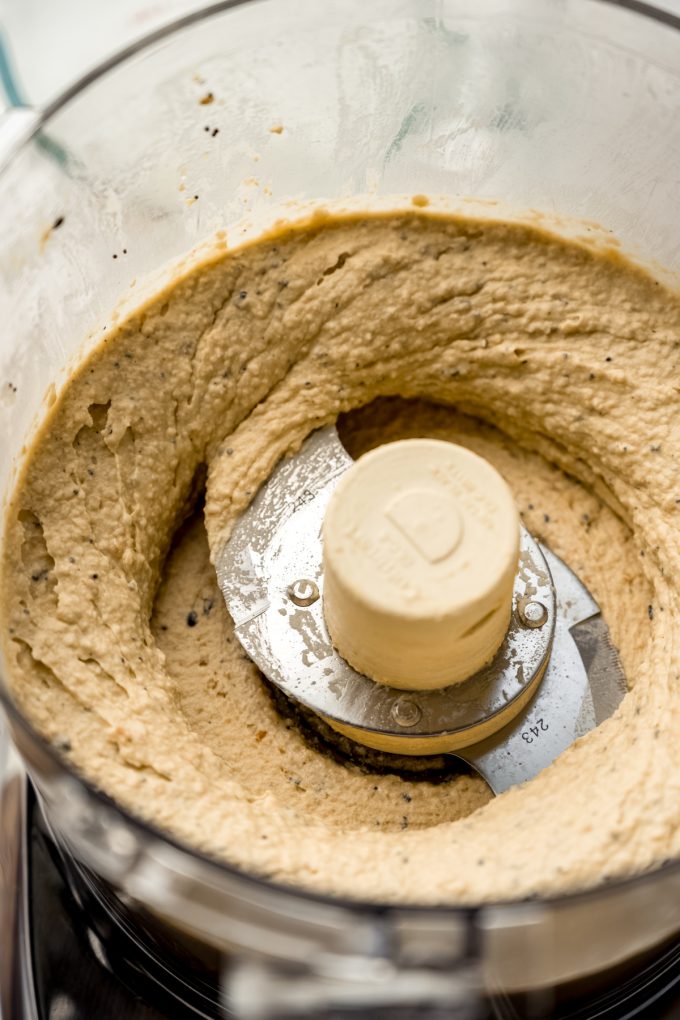 Everything bagel hummus blended in the drum of a food processor.