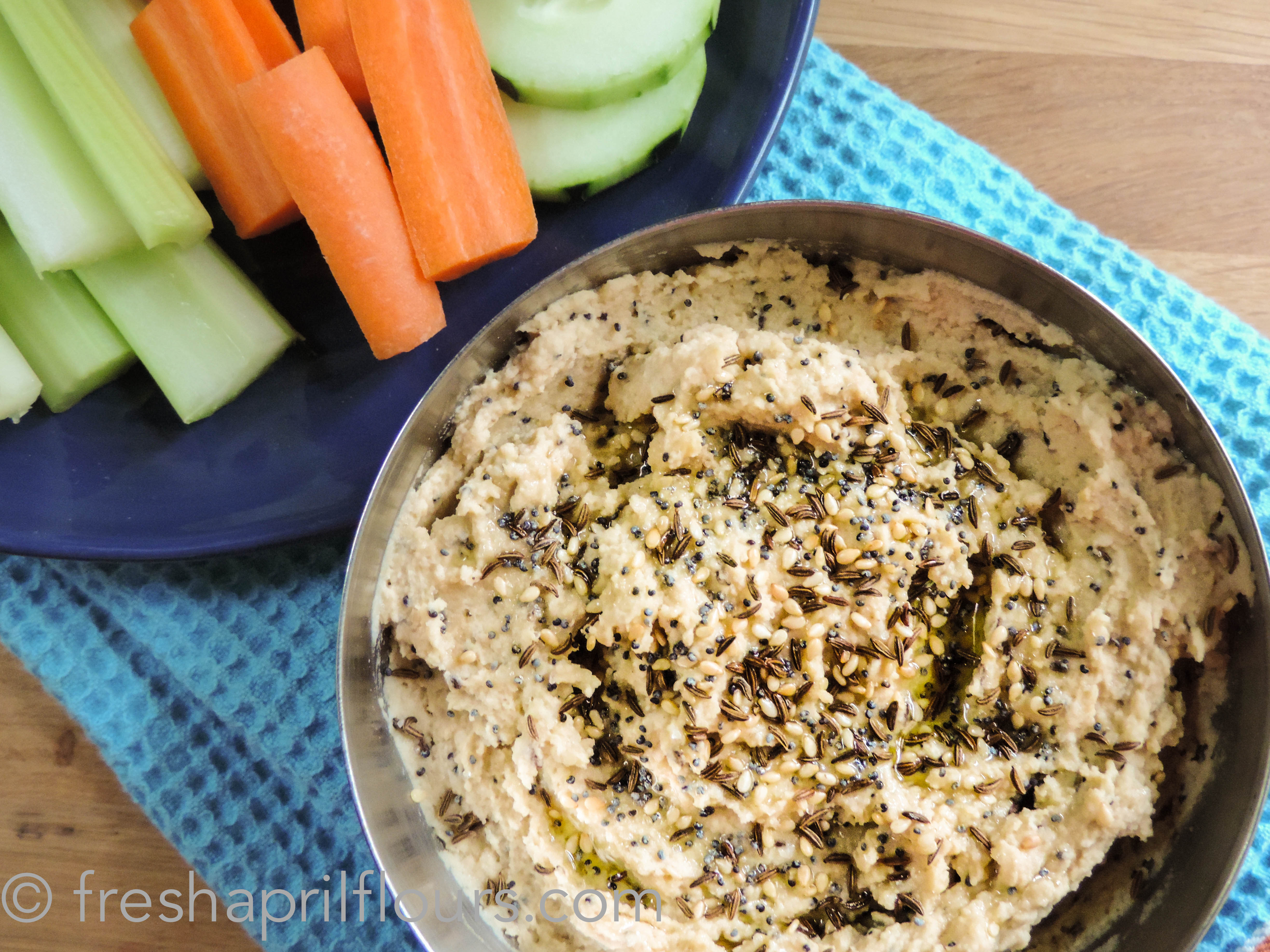 aerial photo of everything hummus in a bowl with veggies