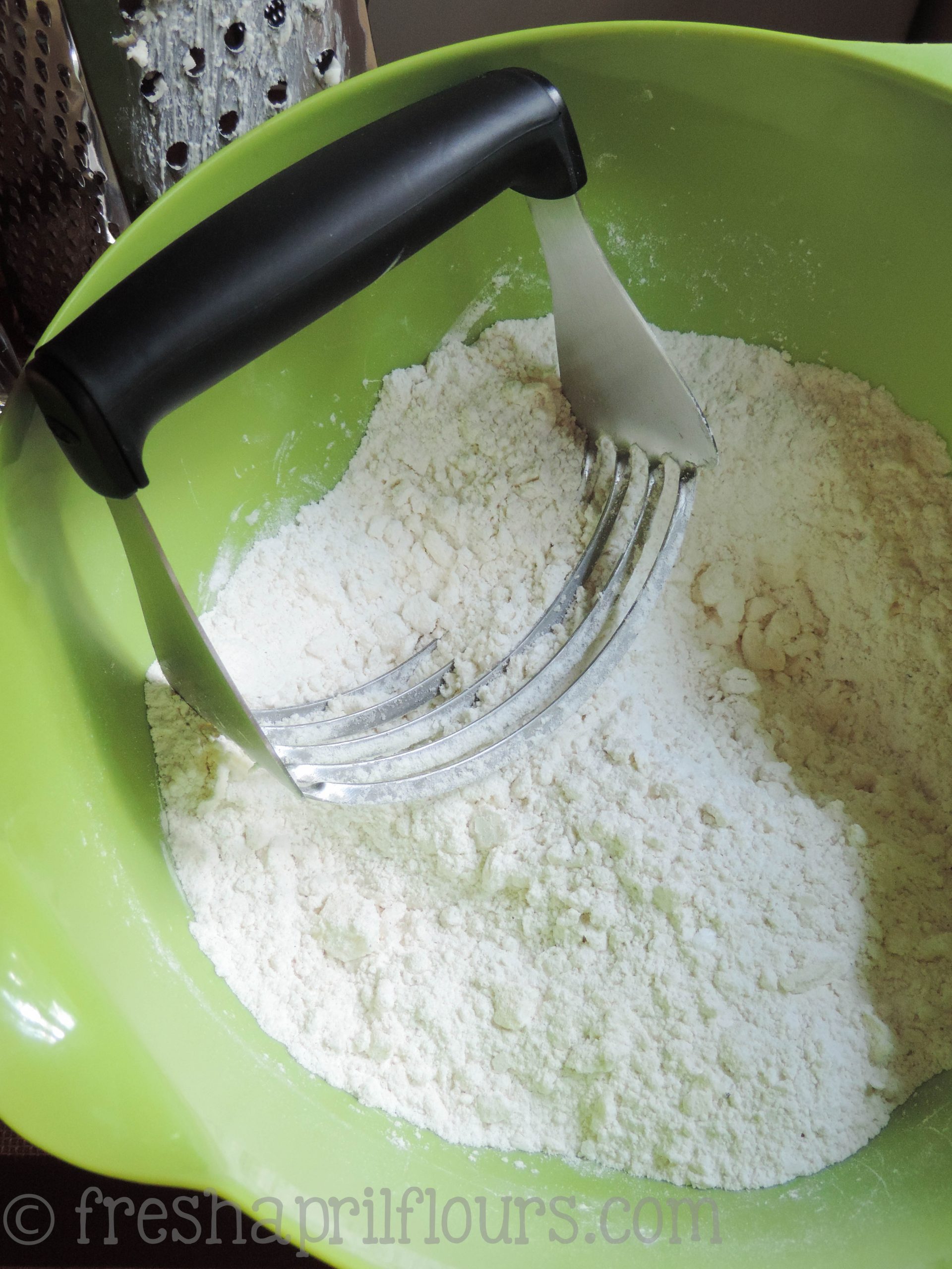 pastry cutter cutting butter into scone dough