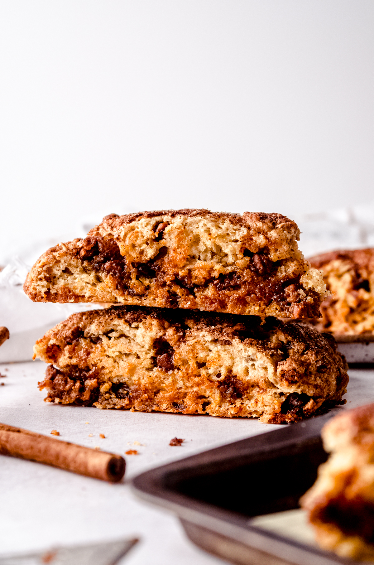 A stack of two cinnamon chip scones on a surface.
