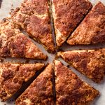 Aerial photo of cinnamon scones on parchment paper.
