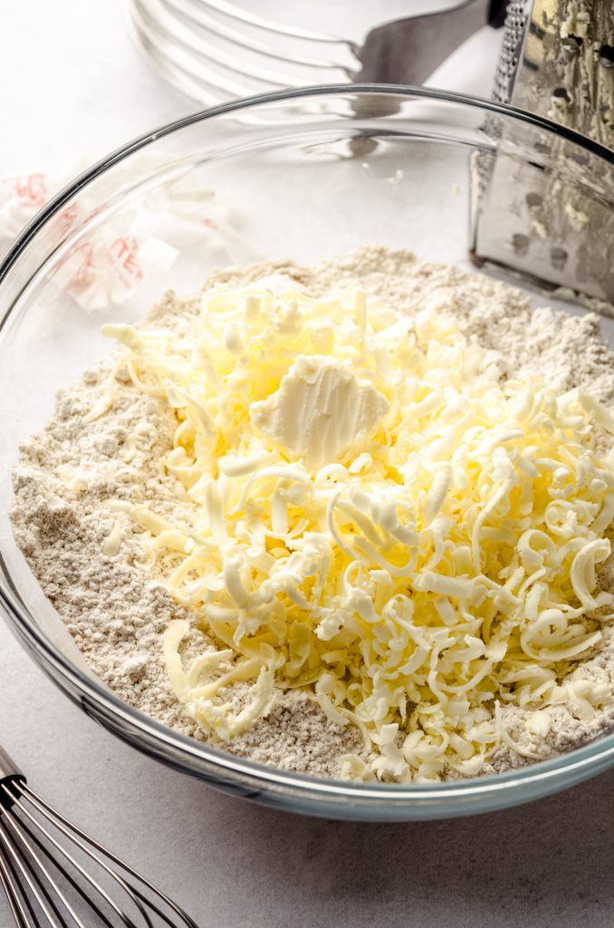 Frozen butter grated into a bowl of dry ingredients to make scones.