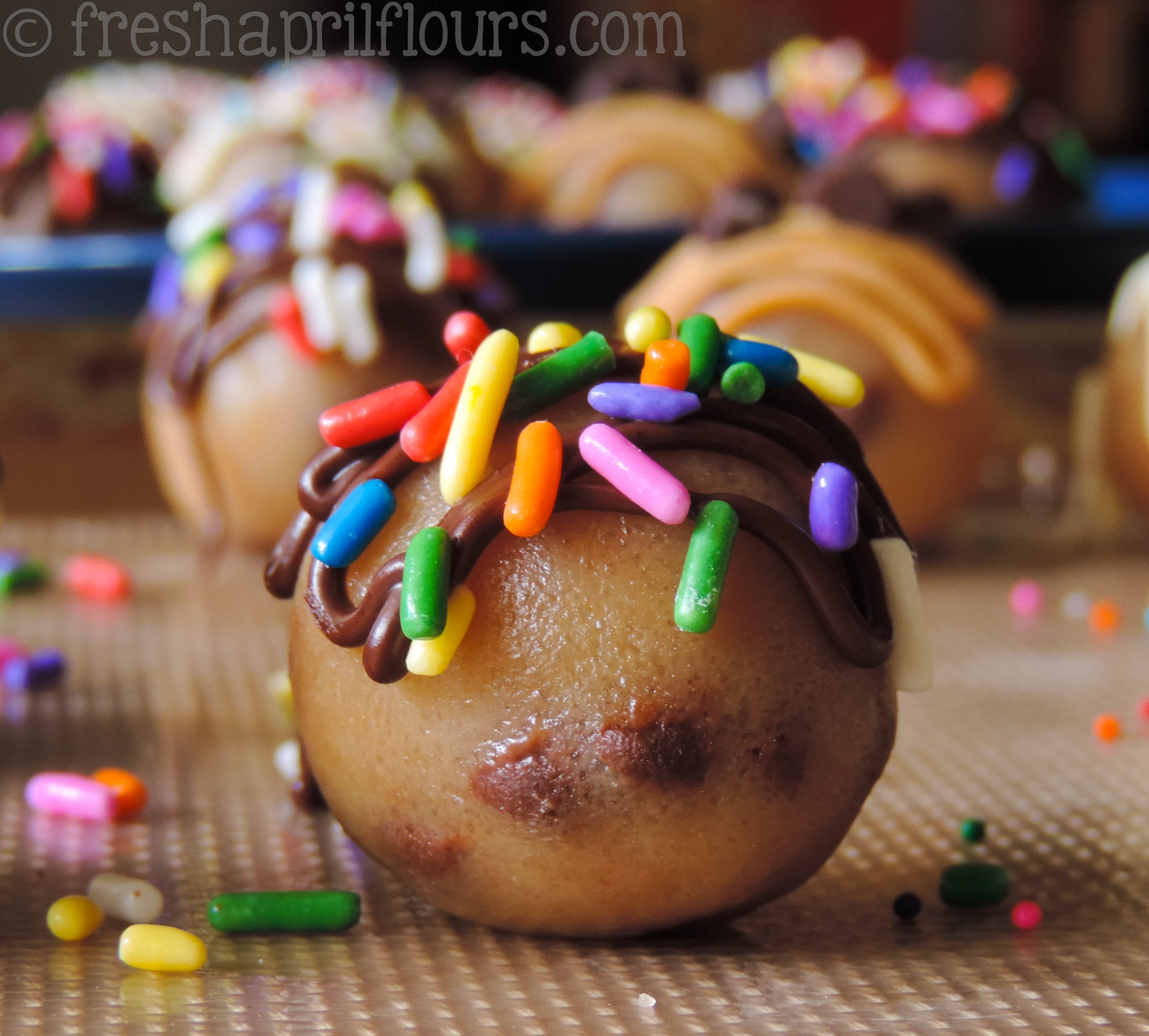 cookie dough bite with chocolate drizzle and sprinkles