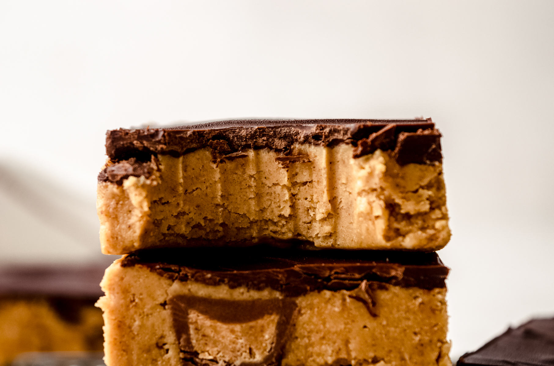 A closeup shot of a peanut butter bar with a bite taken out of it.