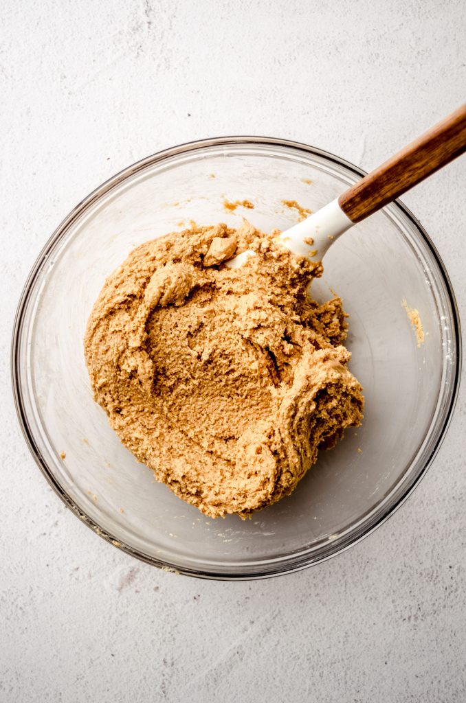 Aerial photo of peanut butter bar filling with a spatula in the bowl.