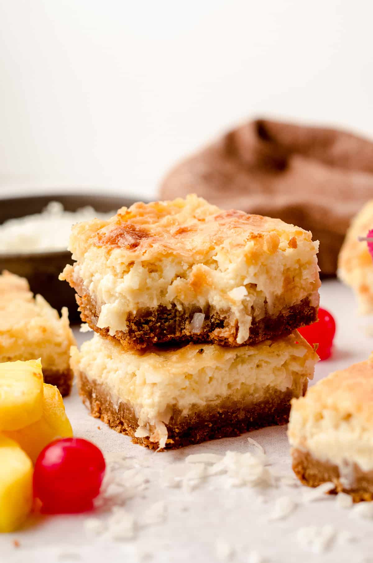 piña colada bars stacked on top of each other and the one on top has a bite taken out of it