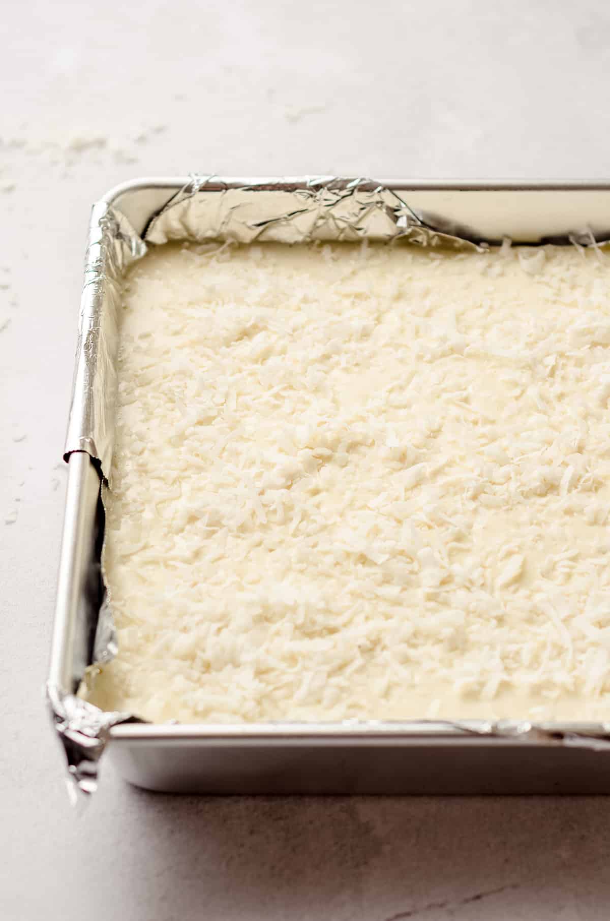 batter for piña colada bars in a pan ready to bake