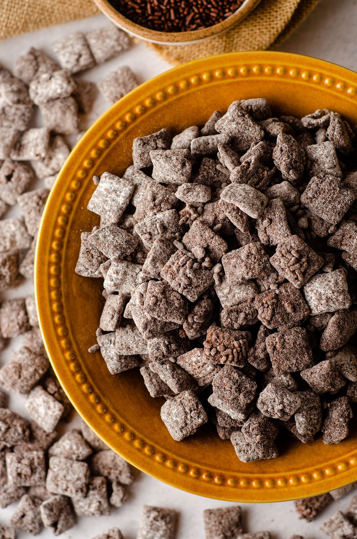 brownie batter puppy chow in a golden yellow bowl