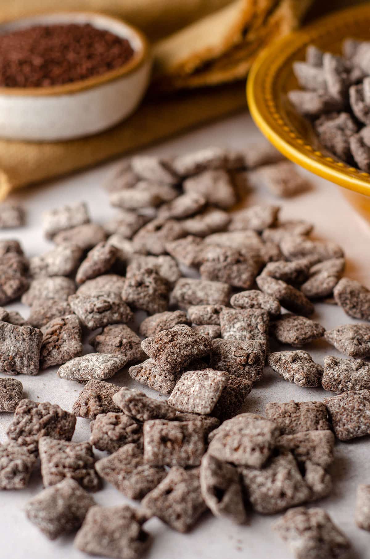 brownie batter puppy chow scattered on a white surface