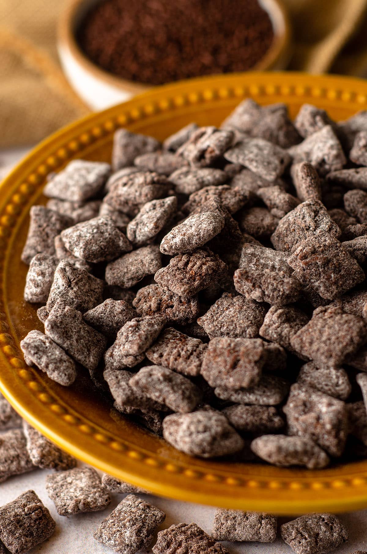 brownie batter puppy chow in a golden yellow bowl