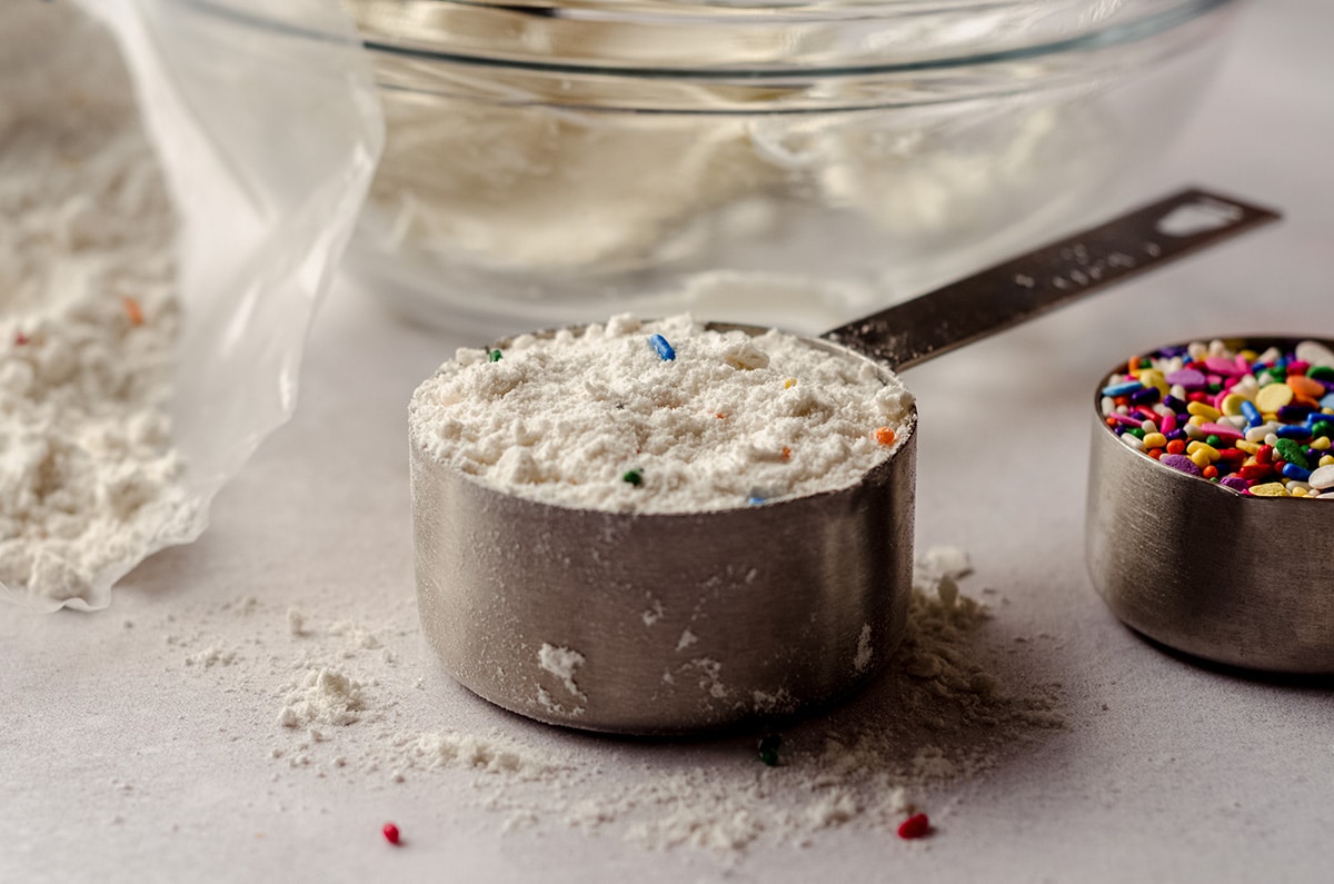 measuring cup full of dry funfetti cake mix