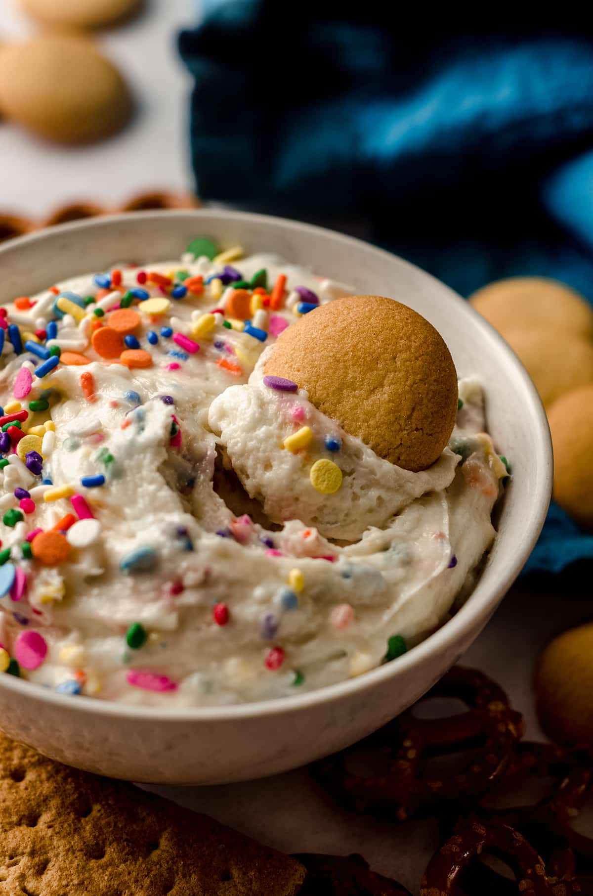 cake batter dip in a bowl with a nilla wafter stuck in it