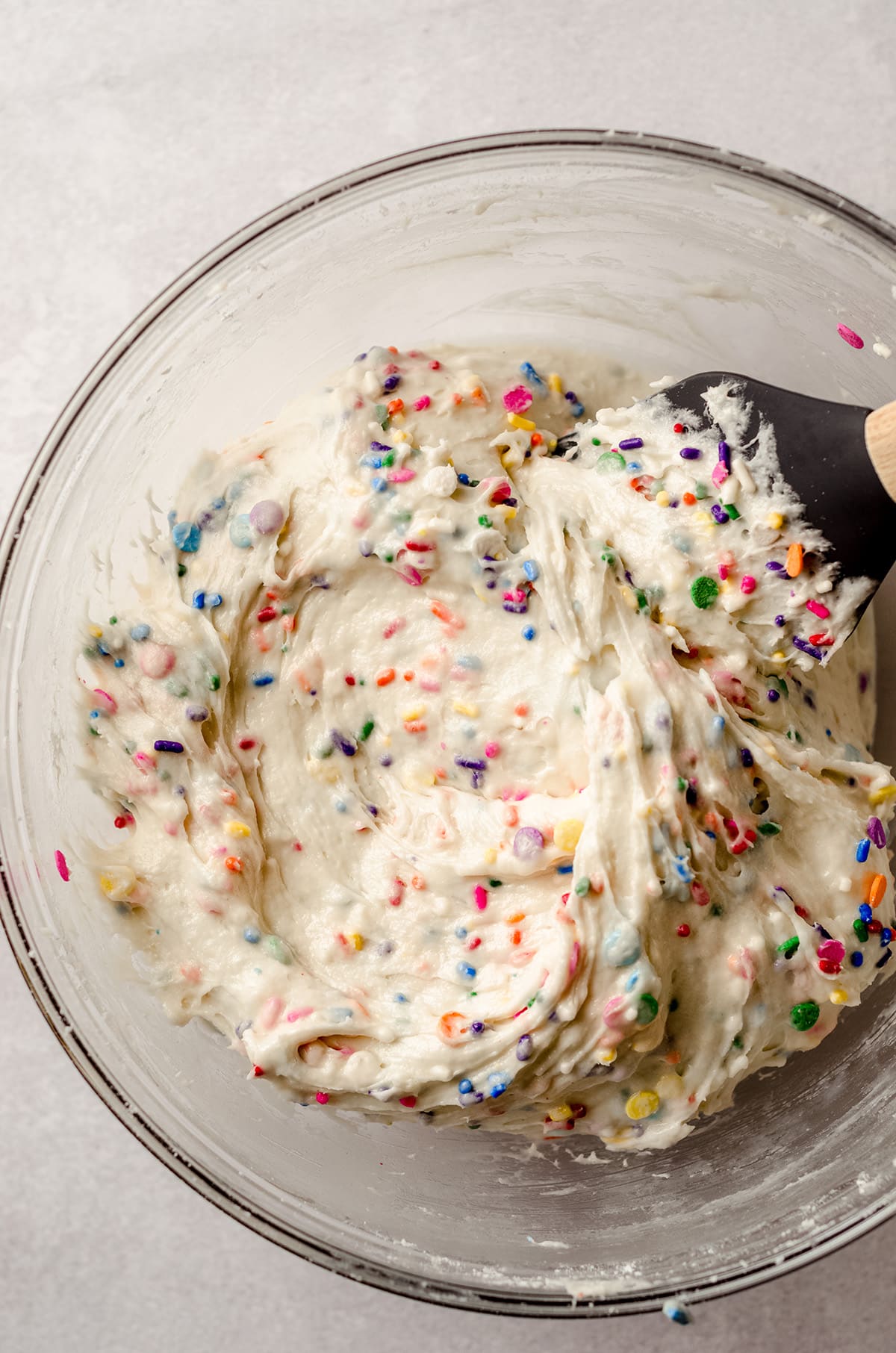 cake batter dip in a glass bowl with a spatula