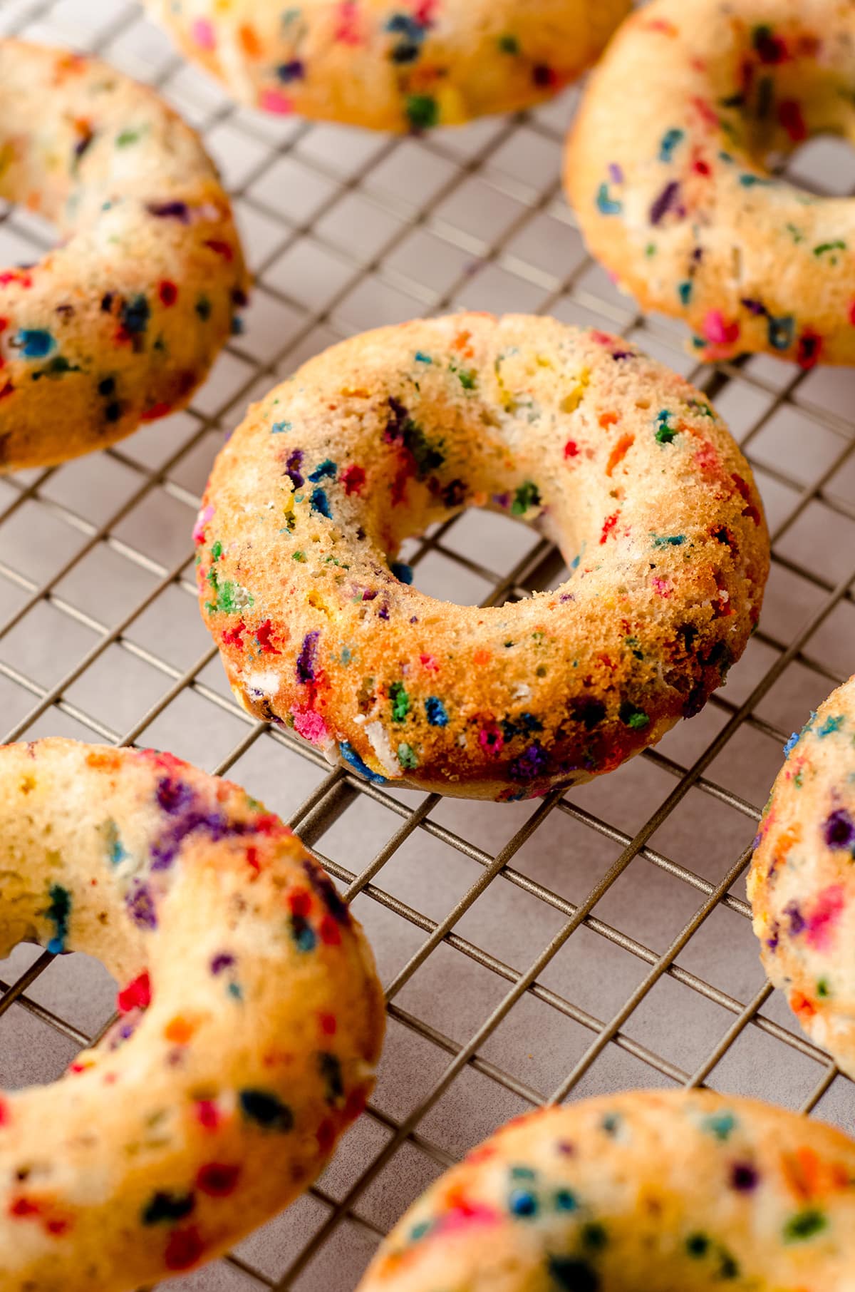 baked funfetti donuts cooling on a cooling rack