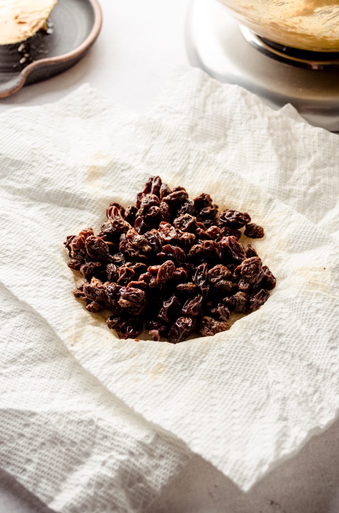 Raisins that had been soaking in water drying off on a paper towel.