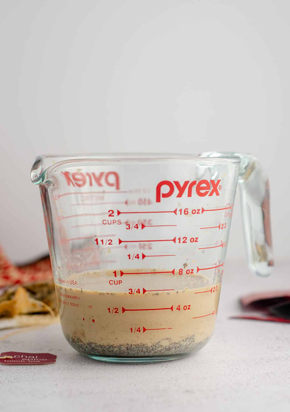 chai-infused milk in a glass measuring cup