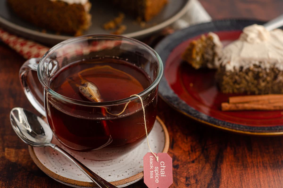 cup of chai tea on a saucer with a spoon