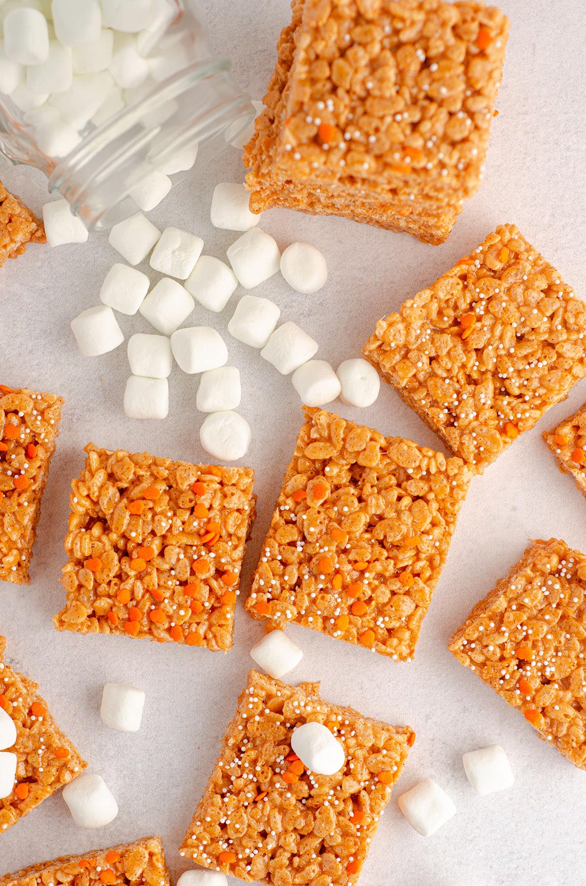 aerial photo of pumpkin rice krispies treats surrounded by mini-marshmallows