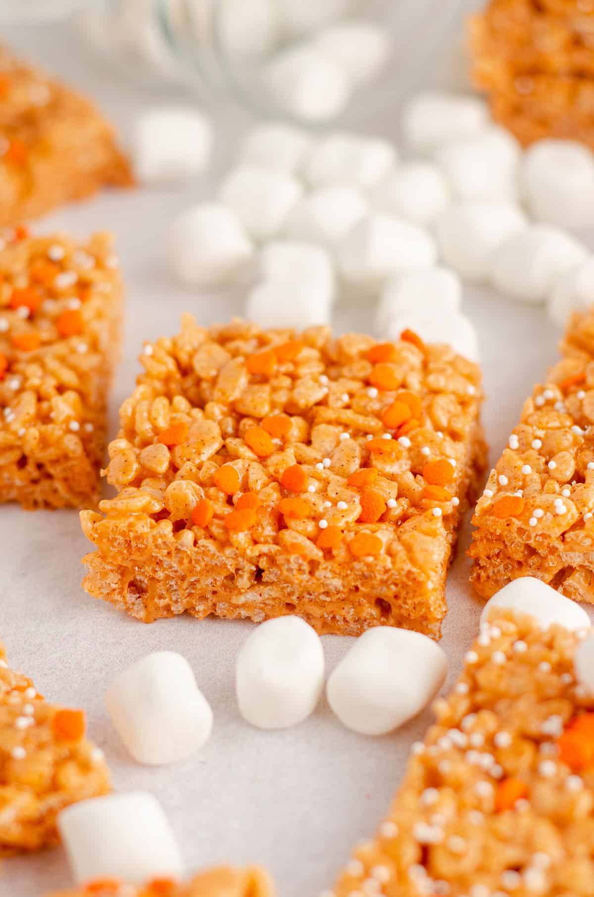 pumpkin rice krispies treats surrounded by mini-marshmallows
