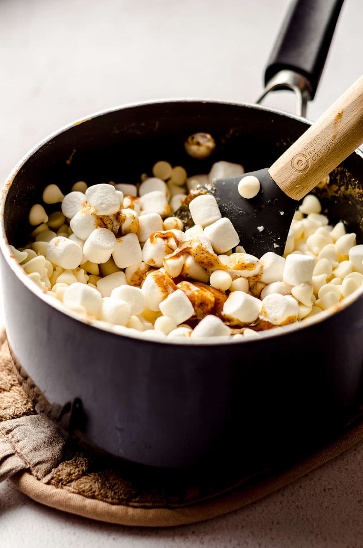 stirring ingredients in a saucepan for pumpkin fudge