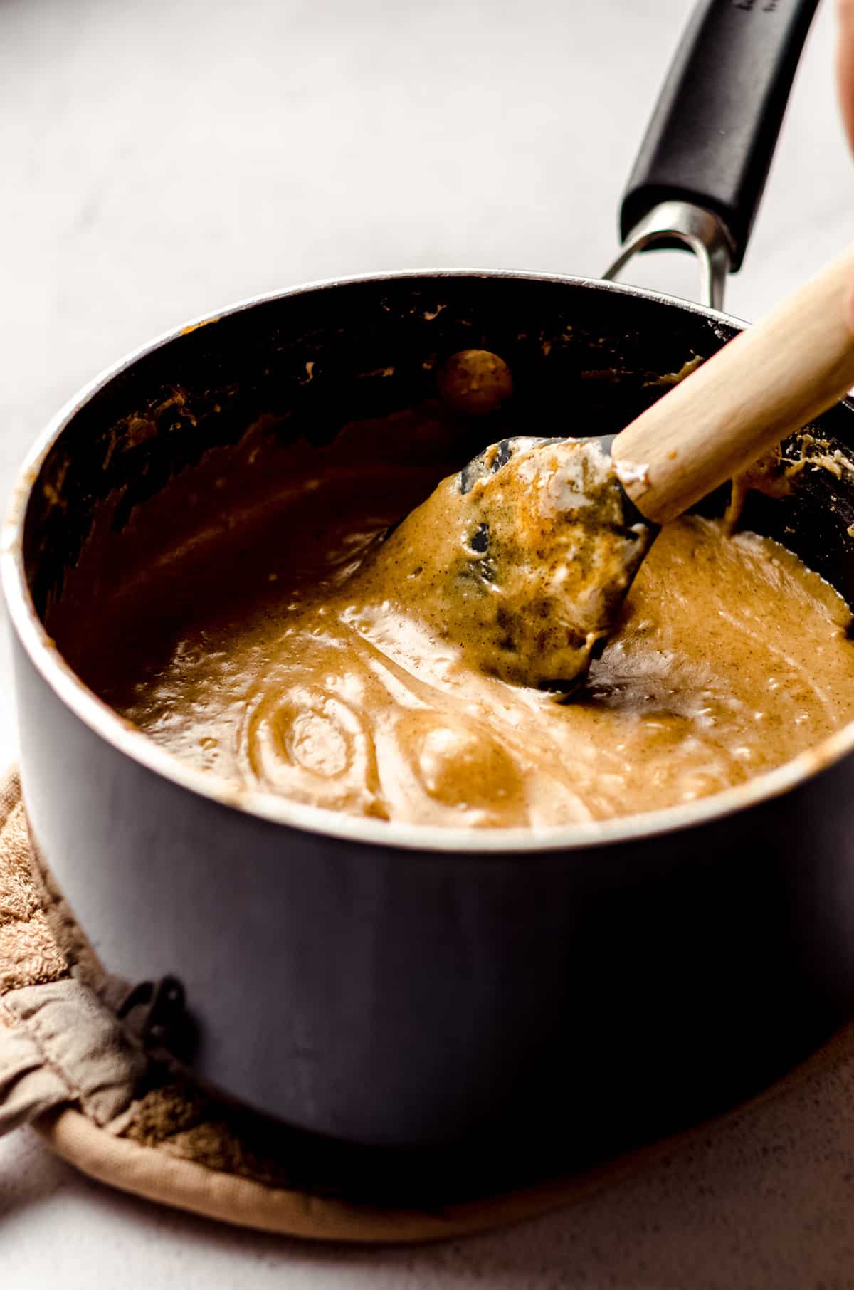stirring ingredients in a saucepan for pumpkin fudge