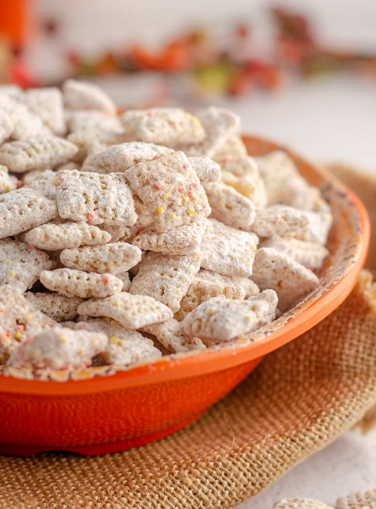 pumpkin spice puppy chow in an orange bowl