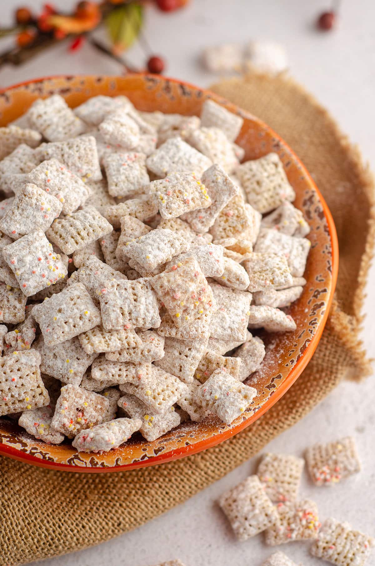 pumpkin spice puppy chow in an orange bowl