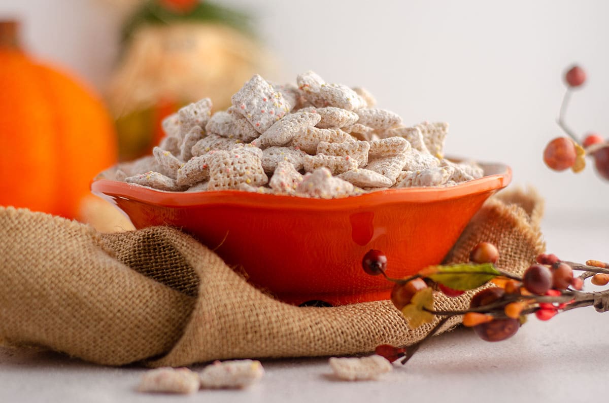 pumpkin spice puppy chow sitting in an orange bowl