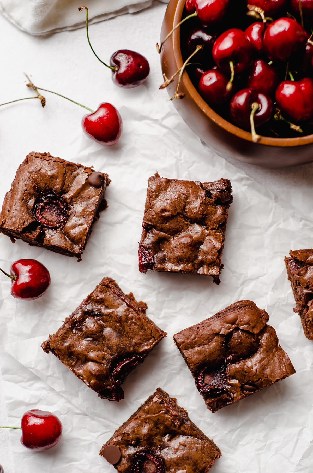 aerial photo of cherry brownies and a bowl of cherries