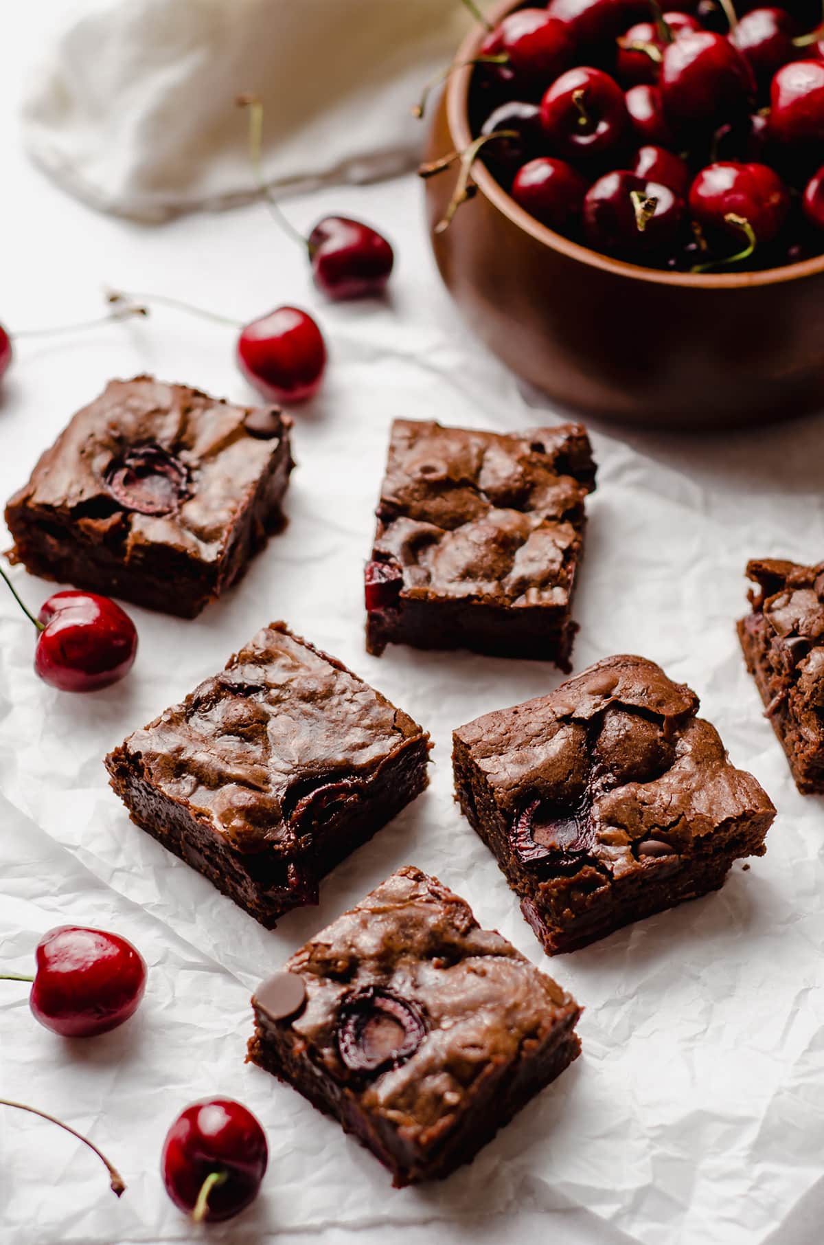 cherry brownies with a bowl of cherries