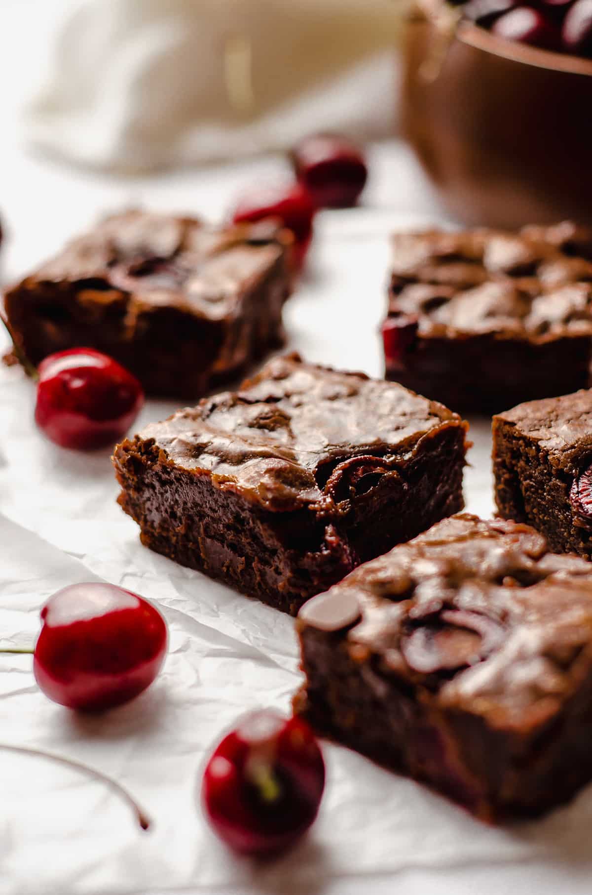 cherry brownies with a bowl of cherries