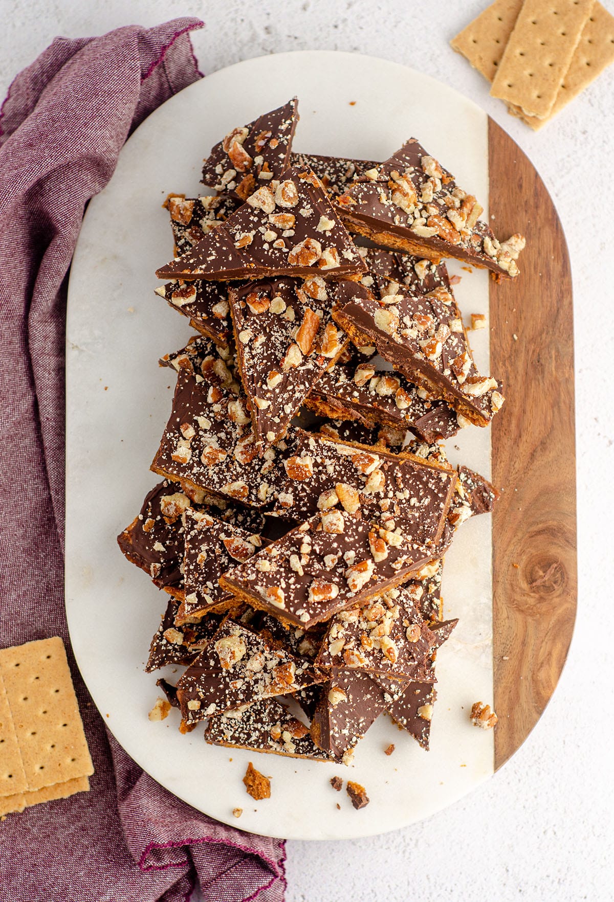 aerial photo of pile of graham cracker toffee bark sitting on a marble cutting board