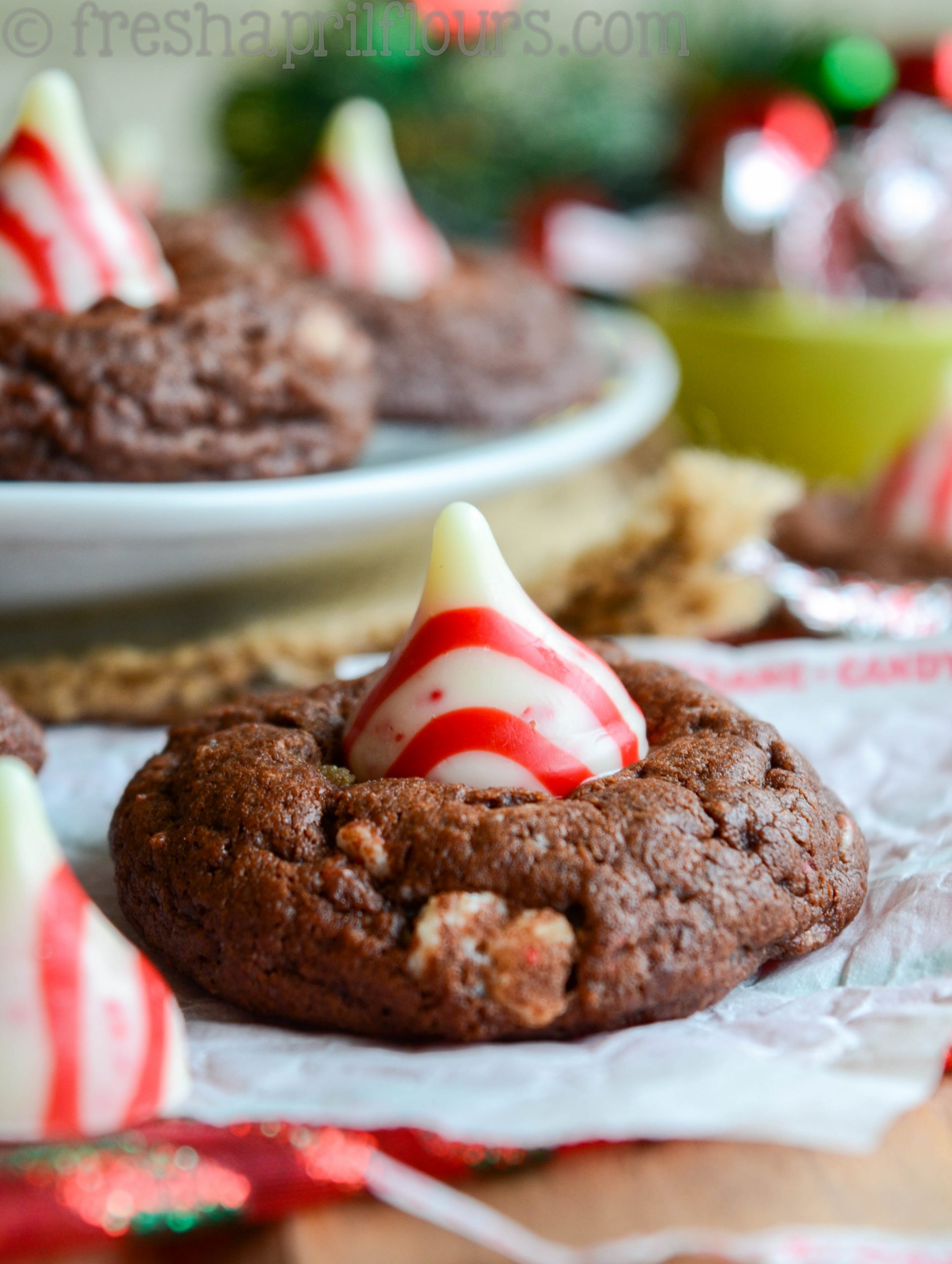 Chocolate Peppermint Blossoms: A holiday take on the classic "blossom" cookie! A simple chocolate cookie speckled with chopped candy cane Hershey's Kisses and topped with a swirly whole one.