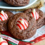 Chocolate Peppermint Blossoms: A holiday take on the classic "blossom" cookie! A simple chocolate cookie speckled with chopped candy cane Hershey's Kisses and topped with a swirly whole one.