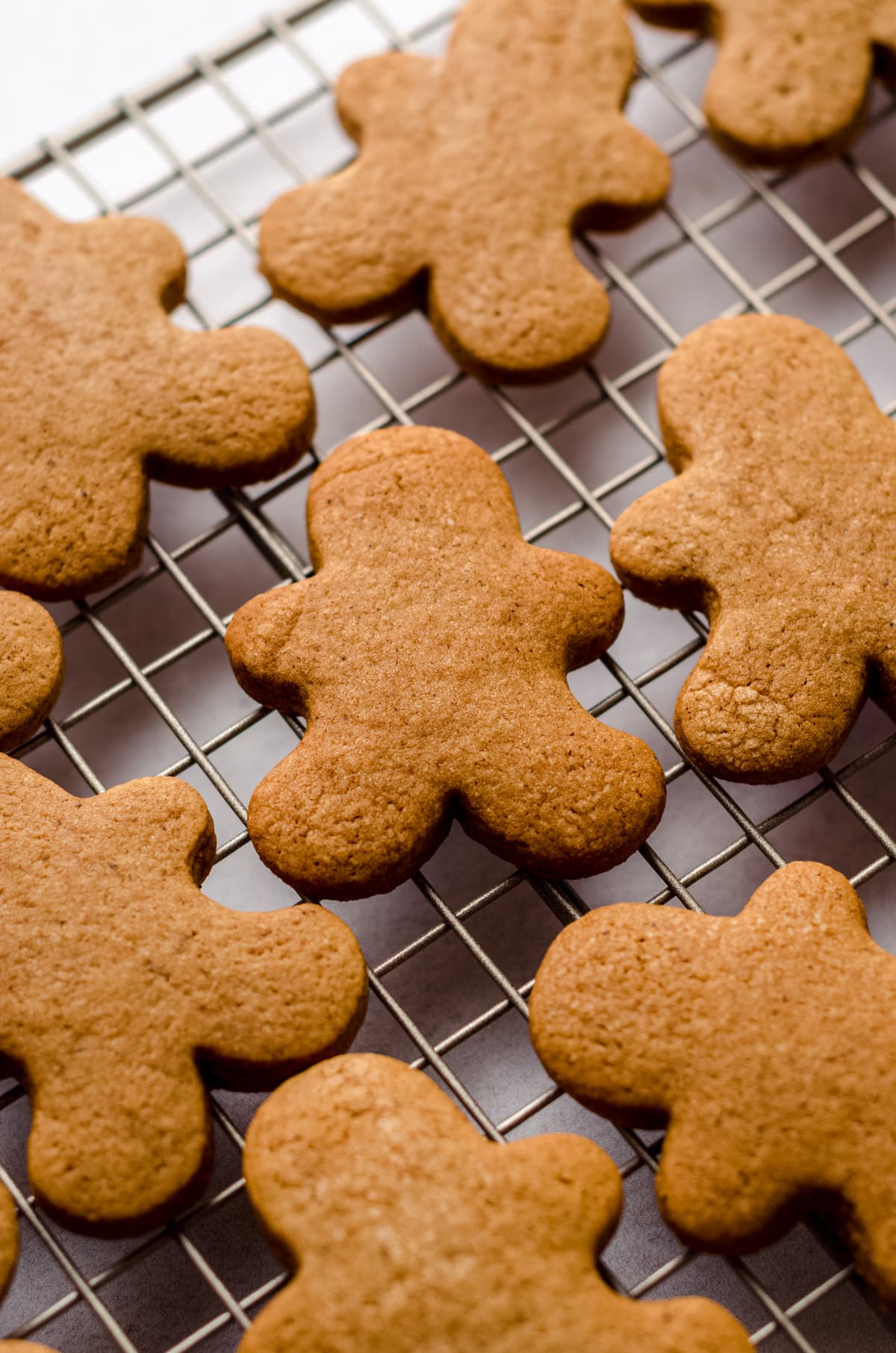 gingerbread people on a wire cooling rack ready to be decorated