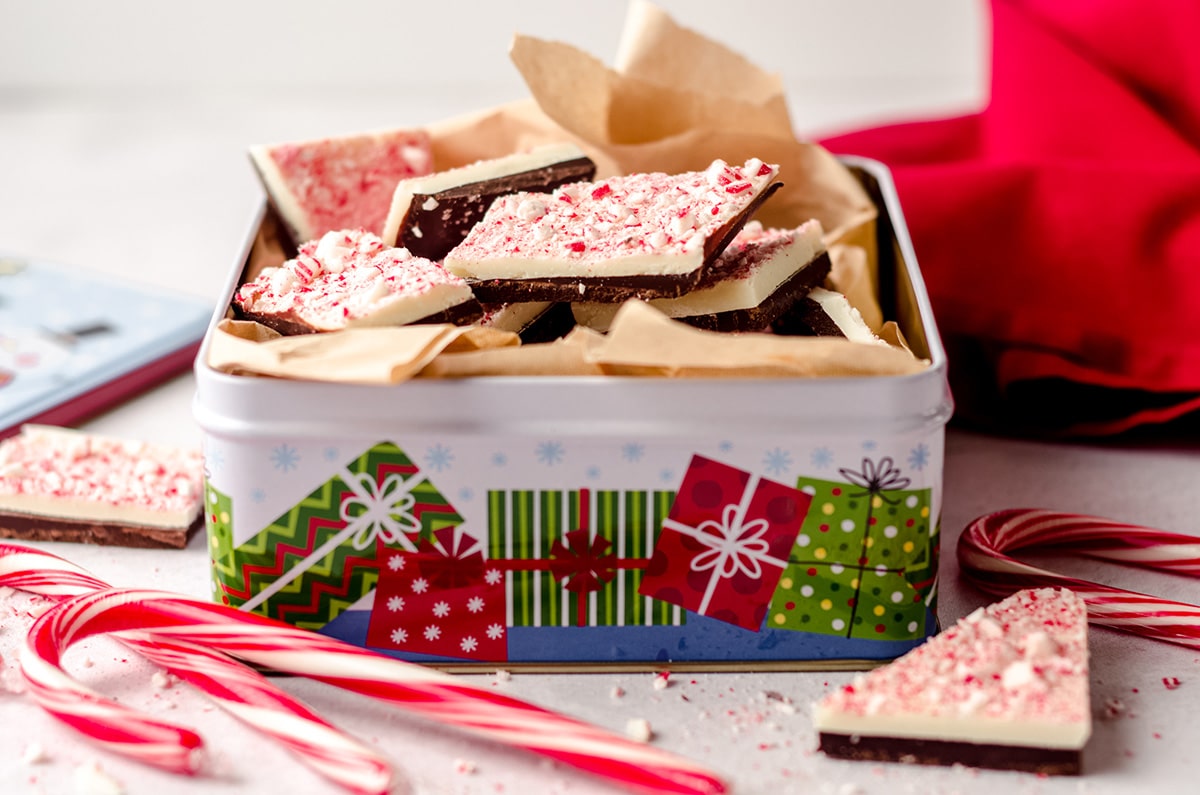 peppermint bark pieces in a tin with parchment paper