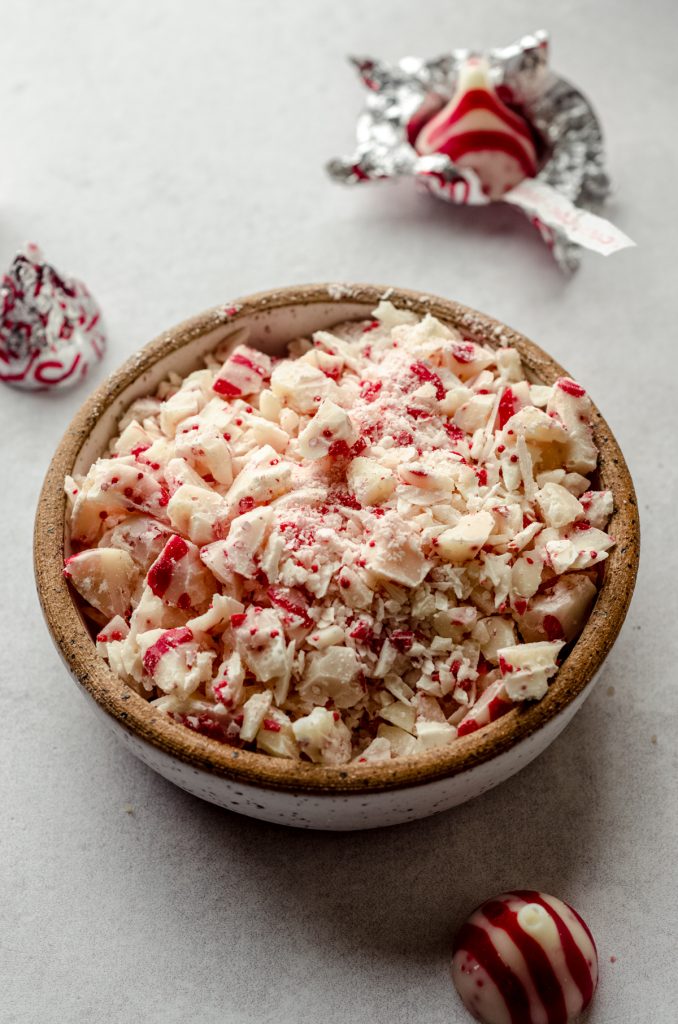 A bowl of chopped candy cane Kisses.