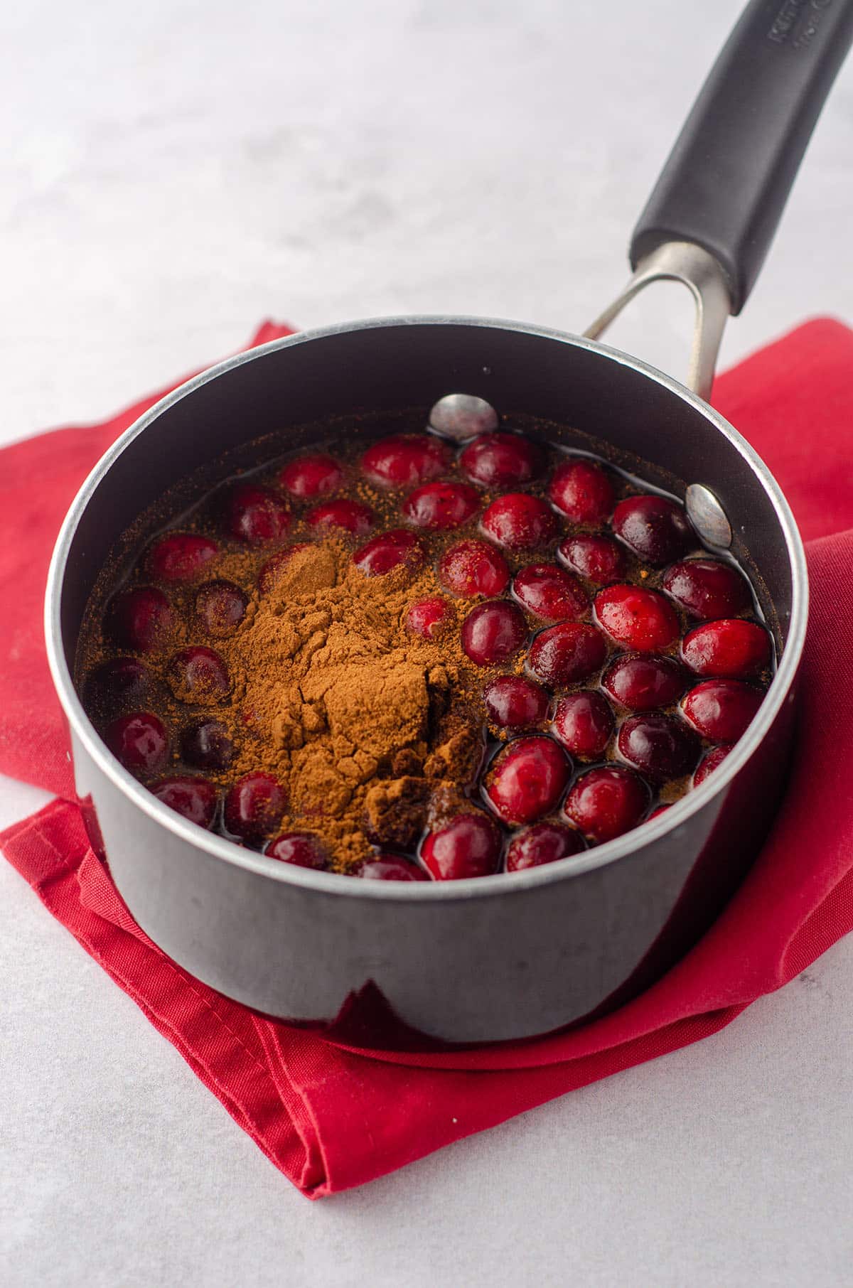 cranberries and cinnamon in a saucepan