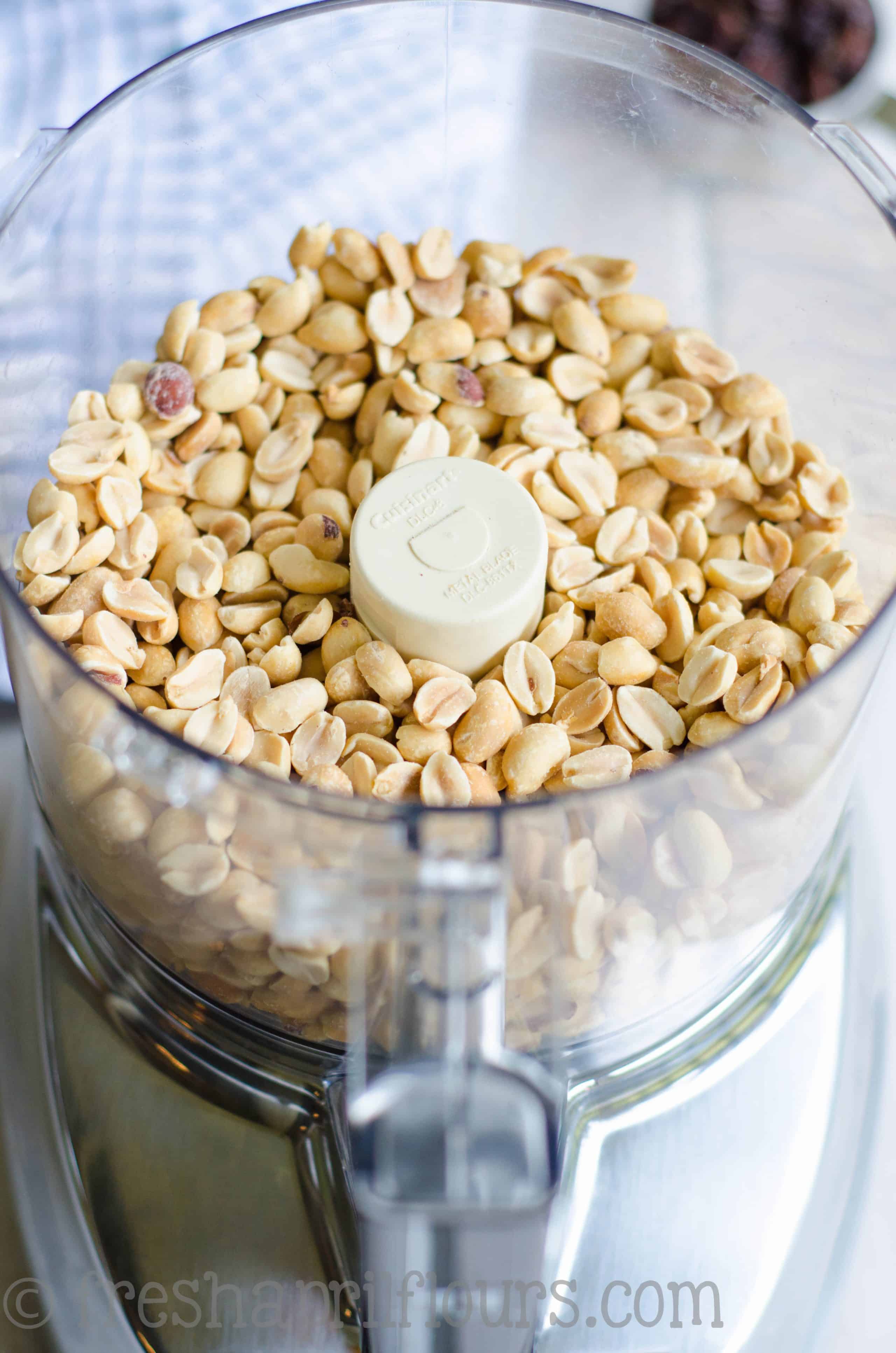 peanuts in the bowl of a food processor to make homemade cinnamon raisin peanut butter