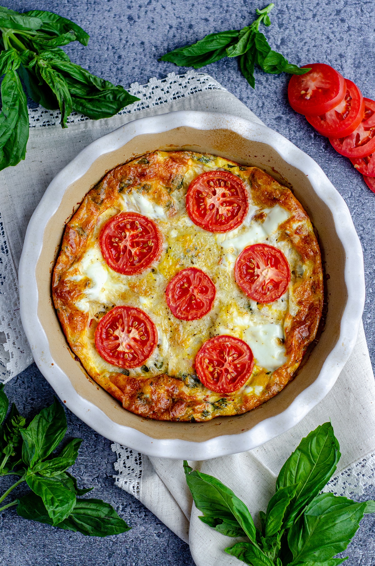 aerial photo of crustless caprese quiche in a pie plate 