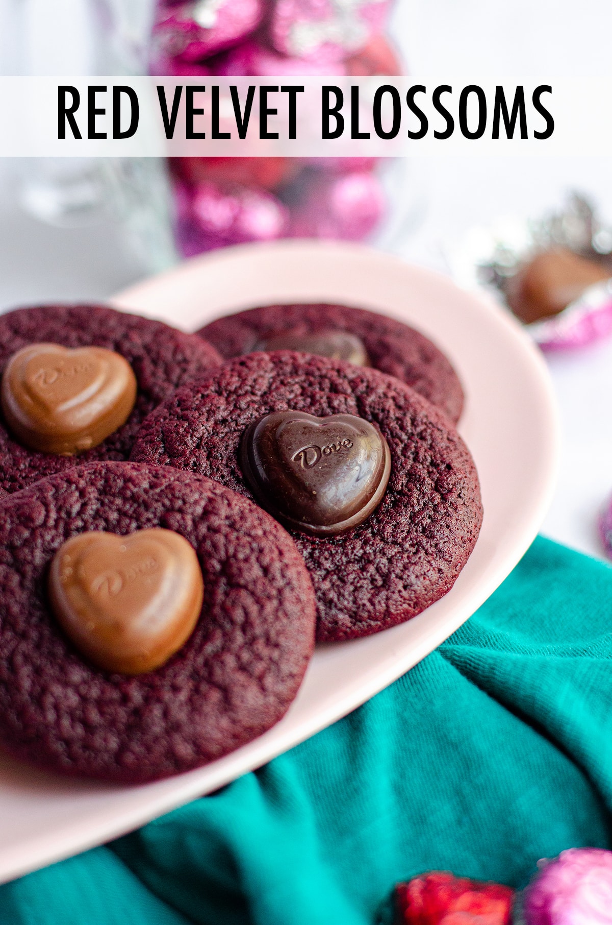 Soft and chewy red velvet cookies, topped with a chocolate heart. No box mix required-- they're made completely from scratch! via @frshaprilflours