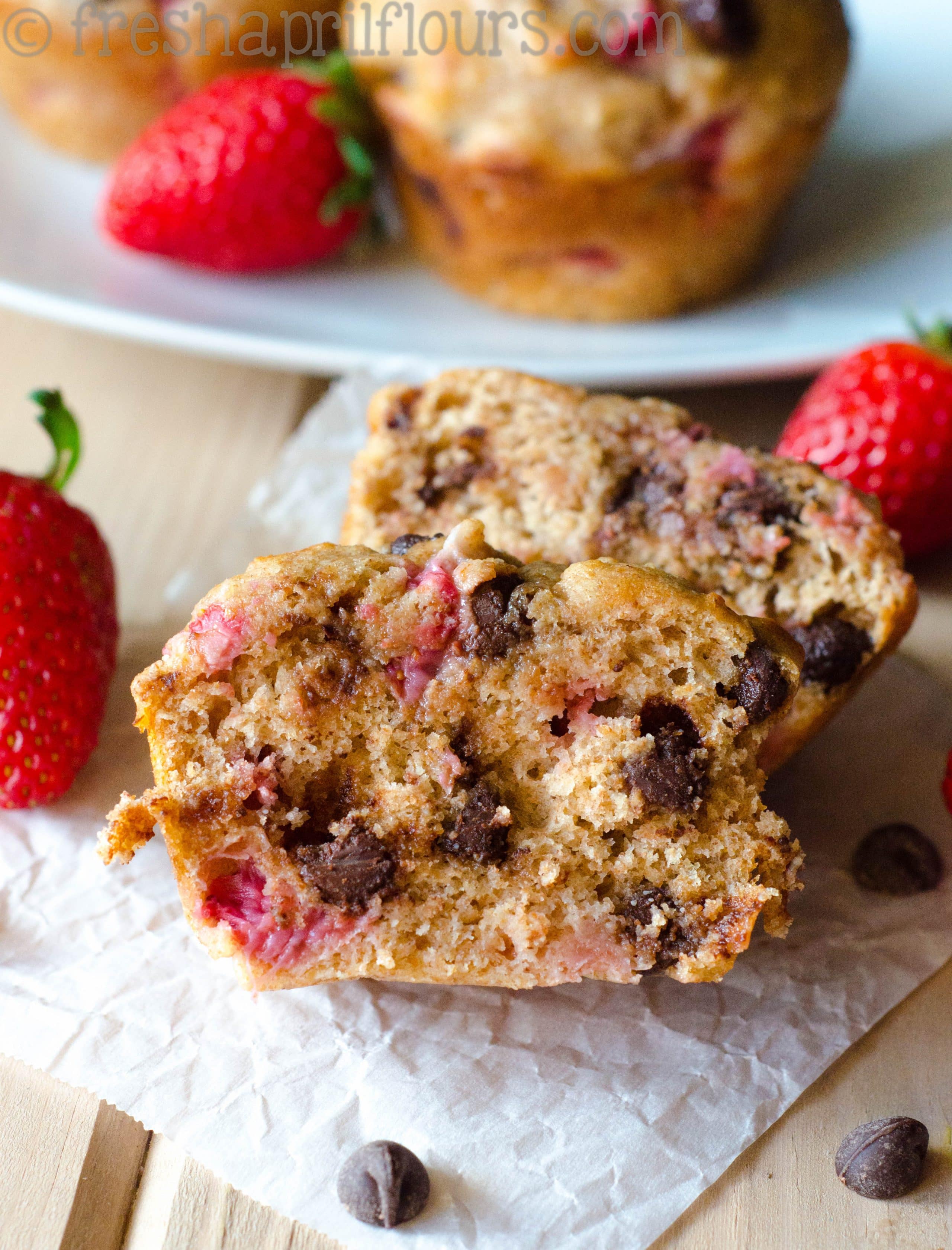 Strawberry chocolate chip muffin cut in half to see the inside of the muffin.