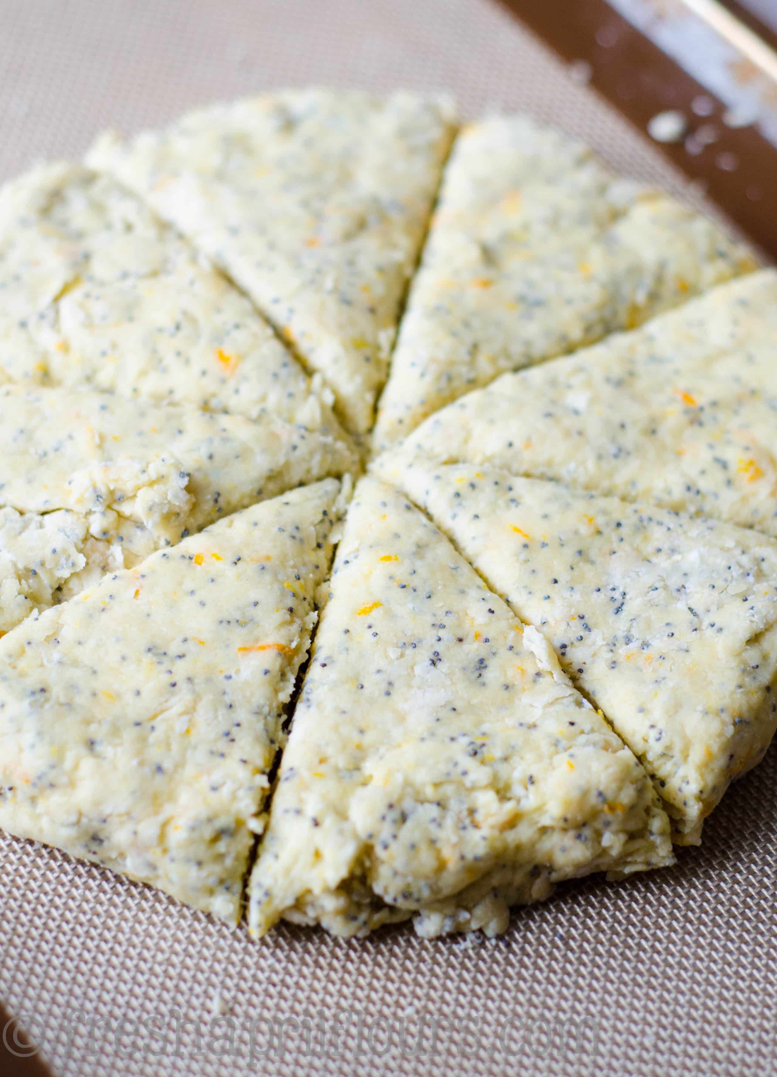 orange poppy seed scone dough on a baking sheet ready to bake