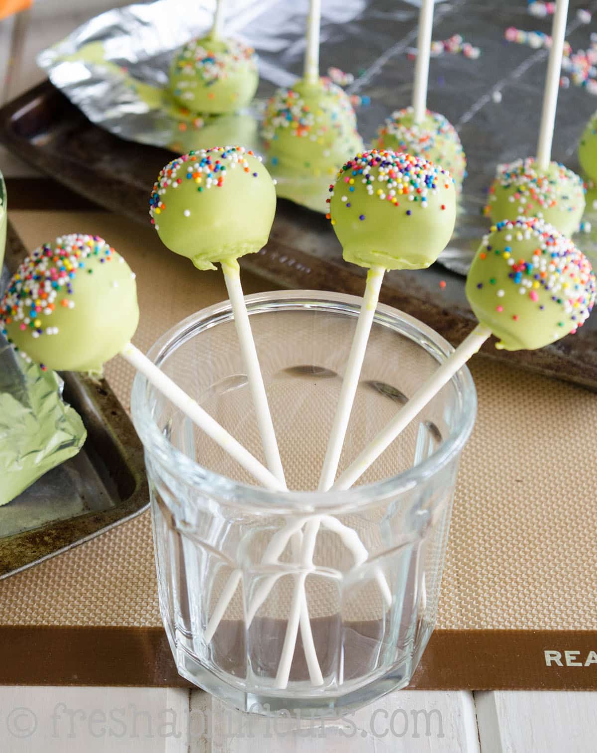 cake pops sitting in a cup to dry